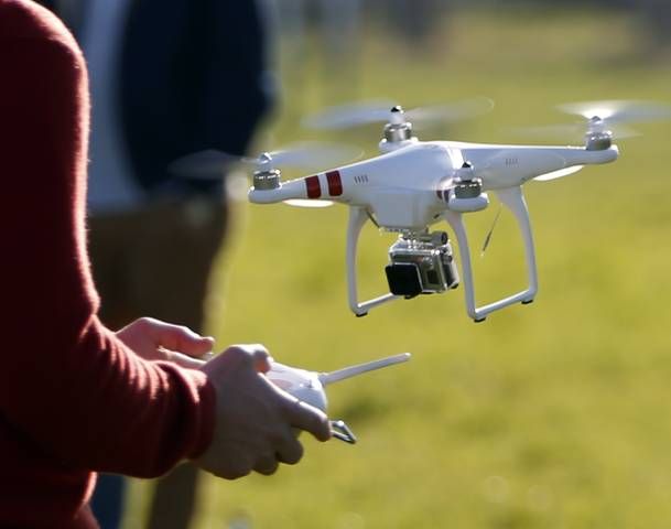 A pilot flies a Phantom drone by DJI company at the 4th Intergalactic Meeting of Phantom's Pilots in an open secure area in the Bois de Boulogne, western Paris